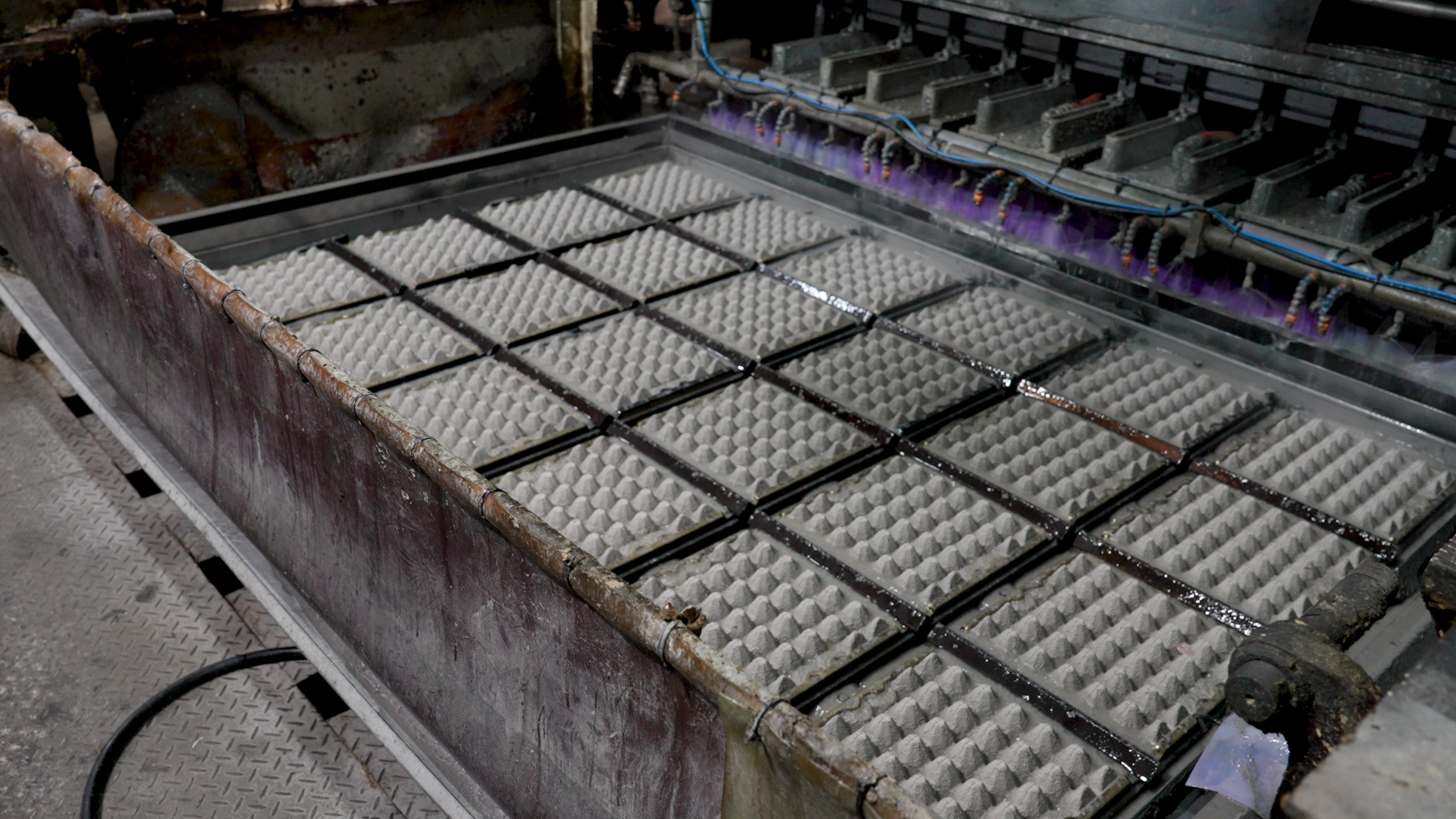 Forming stage of grey 30-count molded-pulp egg trays at PN Greentec